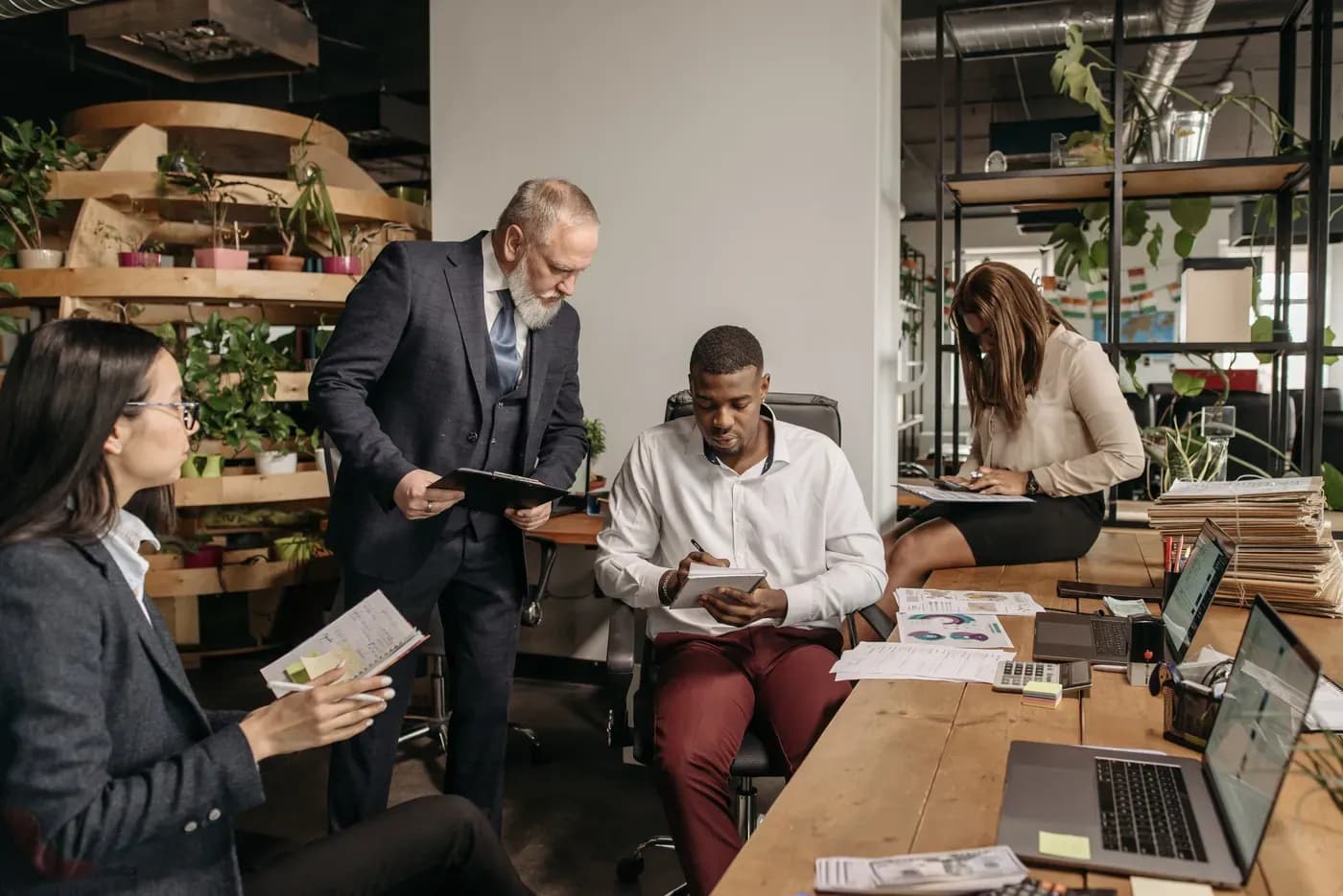 Diverse professional team meeting in a bright contemporary workplace.